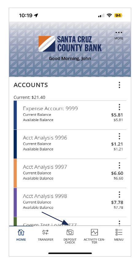 Image of the Santa Cruz County Bank mobile appâ€™s home page after login with a list of accounts with current and available balances. A footer consists of: Home, Transfer, Deposit Check, Activity Center and Menu. Deposit Check is noted.
