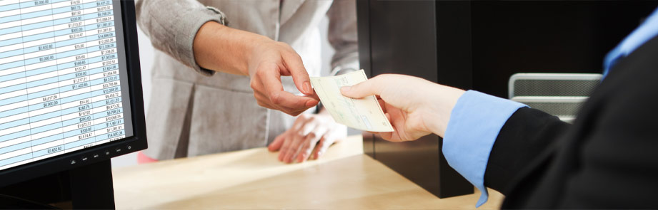 Person handing a check to another