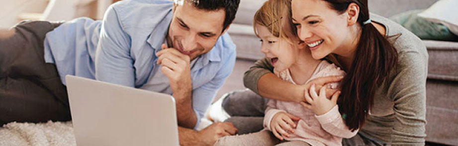 A family using online banking on their laptop